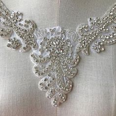 Shinny Bridal Rhinestone Applique V Neck Diamante Appliques Sash Applique DIY Bridal Dress Applique Crystal Sweet Heart wedding appliqueSize:  Width: 4.7" (12 cm)Length: 8.7" (22 cm)Perfect for a DIY bridal garter, bridal dress, wedding dress, bridal sash, belts, headpiece, baby headband (as well as many other DIY projects).  Stones are all prong set, and sewn into the mesh backing.Price is for one piece, more in stock. We offer special discounts for designers and wholesale orders!You can choose Fitted Wedding Dress With Rhinestones, Fitted White Crystal Bridal Accessories, Dress Applique, Wedding Applique, Diy Bridal, Millinery Hats, Rhinestone Appliques, Bridal Sash, Bridal Garter