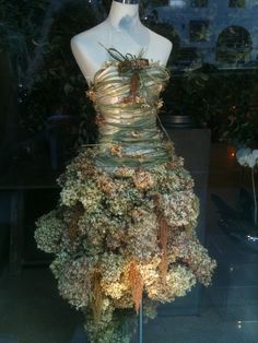 a mannequin dressed in a dress made out of flowers