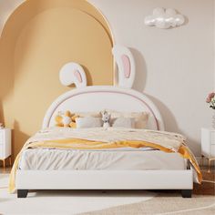 a white bed sitting in a bedroom next to a dresser and mirror with an animal head on it