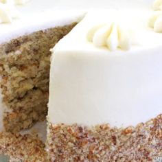 a close up of a cake with white frosting