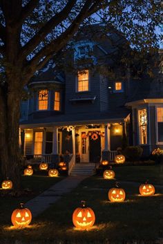 pumpkins lit up in front of a house at night