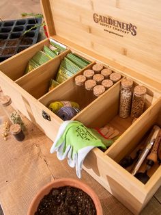 a wooden box filled with lots of gardening supplies