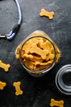 homemade dog biscuits in a glass jar on a table with the words gluten free homemade dog biscuits