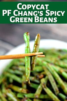 green beans in a white bowl with chopsticks on the side and text overlay that reads copycat pf change's spicy green beans