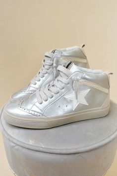 Step up your sneaker game with PAULINA. These vintage-inspired hi-tops add a cool, quirky touch to any outfit, with their bold colors and unique textures. Perfect for pairing with a jersey dress for an on-trend look.

-Color: White/Silver

-Runs True To Size Cowgirl Couture, Sneakers Street, Unique Textures, Wedge Heel Boots, Jumpsuit Outfit, Sneaker Games, Plus Size Shopping, Kendra Scott Jewelry, Plus Dresses