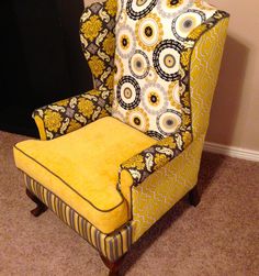 a yellow chair sitting on top of a carpeted floor