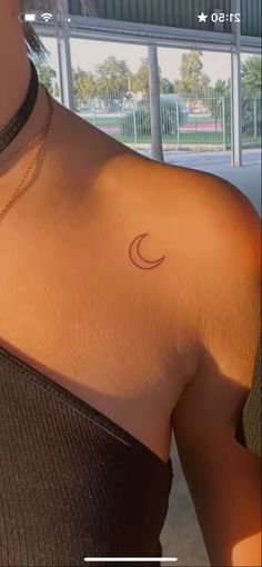 a woman with a crescent tattoo on her chest