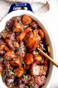 a white bowl filled with meat and vegetables