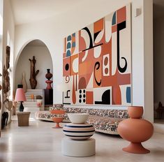 a room filled with lots of different colored vases and lamps on top of tables