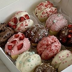 a box filled with lots of different flavored donuts