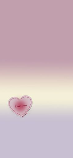 a pink heart shaped object sitting on top of a purple and white background with the word love written in it