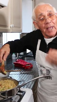 an old man is cooking some food on the stove and he is surprised at what's in the skillet