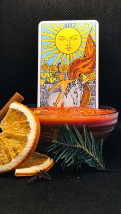 the tarot card surrounded by orange slices and cinnamon sticks