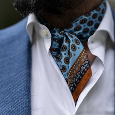 This neckerchief can effortlessly shift your style, whether you're going for a timelessly classic look or something a bit more rakish.The rich medallion pattern in ginger with a touch of navy on a light blue background takes inspiration from the charm of Tuscany’s cobblestone streets.Crafted from luxurious silk twill—a must-have accessory for any man who appreciates refined elegance. Details The classic neckerchief size: Approx. 27" x 27" (70 x 70cm). A comfortably large size that fits most men, Mens Scarf Fashion, Italian Silk Scarf, Sky Blue Background, Dapper Mens Fashion, Mens Fashion Wear, Men's Formal Style, Bandana Styles, Medallion Pattern, A Sky