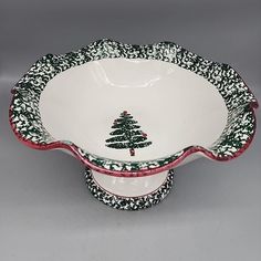 two white and black dishes with red trimmings on each side, one has a christmas tree in the center