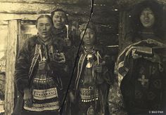 an old black and white photo of three people in native american clothing standing next to each other