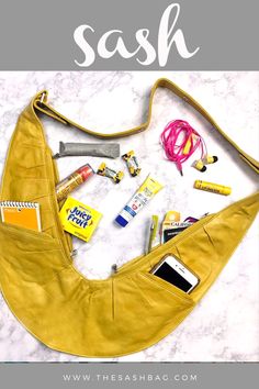 a yellow purse with various items in it and the words sesh written above it