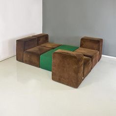 three brown and green chairs sitting next to each other in a room with white floors