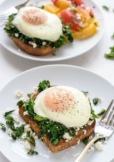 an egg is on top of toast with spinach and feta cheese in the middle