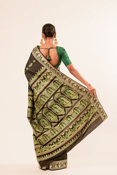 Elevate your traditional and festive wear with our Authentic Black Baluchari Silk Saree. Adorned with intricate handwoven Minakari work in green, this classic Bengal silk saree exudes elegance. Expertly crafted and crafted from high-quality silk, this saree is a must-have for any special occasion. Green Traditional Wear With Motifs, Green Traditional Pre-draped Saree For Ceremonies, Green Pre-draped Saree With Traditional Patterns For Ceremonies, Green Pre-draped Saree With Traditional Patterns, Green Chanderi Traditional Wear With Woven Motifs, Green Traditional Wear With Woven Motifs For Festivals, Green Katan Silk Traditional Wear With Motifs, Green Saree With Motifs In Traditional Drape, Traditional Green Pre-draped Saree