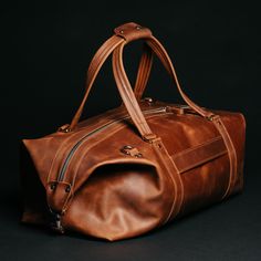 A travel bag is an element of the wardrobe of men and women who go on business trips, short-term vacations, and short weekend trips. The Stout bag will store all your clothes and perfectly complement your look. This leather travel bag impresses with its appearance thanks to the natural material and metal fittings: Spacious and functional, roomy. With a large volume of 34 liters, you will find a place for everything you need to take with you: clothes, shoes, cosmetics, appliances, personal care p Leather Duffle Bag Men, A Place For Everything, Leather Duffel Bag, Leather Duffel, Mens Travel Bag, Leather Duffle Bag, Leather Travel Bag, Leather Duffle, Duffle Bag Travel