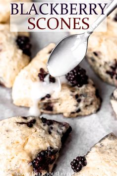 blueberry scones are being drizzled with white icing on top