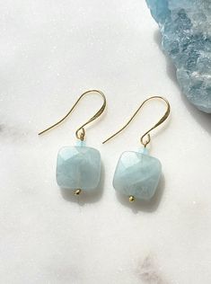 Solazur earrings "Cara--- Different. Comfortable. Good energy. ♧ Aquamarine has been used as a symbol for youth and happiness due to its color. Beautiful and lightweight pair of earrings with a modest spark. Make them yours or offer them as a gift, they will be well received : -) ☆ Aquamarine is March Birthstone crystal. Earrings are made with genuine Aquamarine square beads. On gold plated hooks. Hypoallergenic.  Due to natural stone inclusions, each pair will be a one of a kind jewelry piece. 14k Gold Filled Faceted Earrings For Gift, Handmade Aquamarine Dangle Earrings, Handmade Gold Aquamarine Earrings, Faceted Crystal Dangle Earrings For Gift, Blue Gemstone Earrings, Earrings Square, Square Beads, Birthday Gift For Women, Aquamarine Earrings