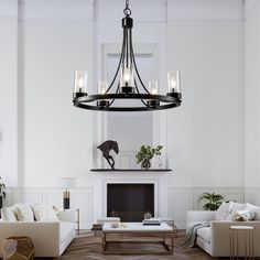 a living room filled with furniture and a fire place next to a wall mounted fireplace