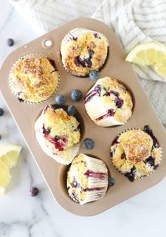 muffins with blueberries and lemon on a tray