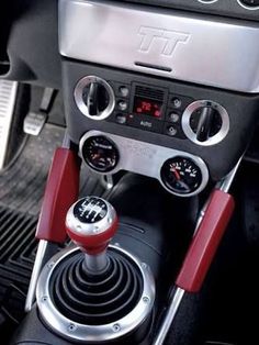 the interior of a car with buttons and gauges