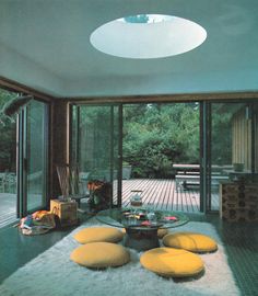 a living room filled with lots of furniture and large sliding glass doors that open up to a deck