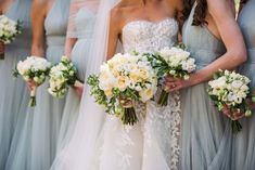 the bridesmaids are holding their bouquets together