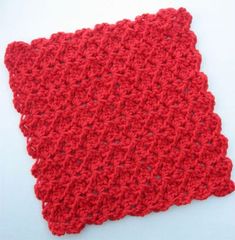 a red crocheted dishcloth on a white surface