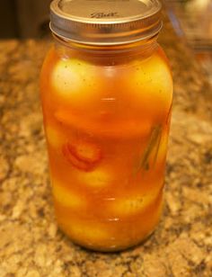 a jar filled with liquid sitting on top of a counter