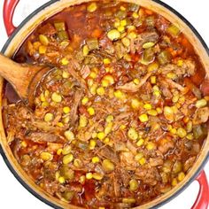 a pot filled with meat and vegetables on top of a stove next to a wooden spoon