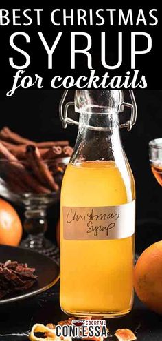 the best christmas syrup for cocktails is in a glass bottle with cinnamon and cloves around it