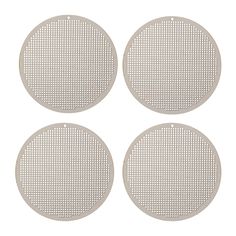 four white round metal plates on a white background