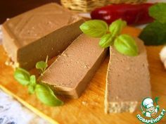 three slices of chocolate cake sitting on top of a cutting board next to garlic and pepper