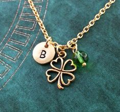 This listing is for a personalized four leaf clover necklace with a hand-stamped initial charm and a lovely green bead. You'll be able to choose your initial from the drop-down menu, as well as chain length and style. Keyrings are also available, just choose that as your option from the drop-down menu. :) **Please see the second photo for scale! This is a VERY SMALL charm. This necklace is made of gold-colored pewter and is hung by a gold-colored brass chain. The initial charm measures 3/8 inch. Personalized Green Jewelry For Best Friend Gift, Green Charm Necklaces For May Birthstone, Green Charm Necklace For May Birthstone, Personalized Round Good Luck Charm Necklaces, Personalized Round Charm Necklace For Good Luck, Personalized Green Jewelry Gift, Personalized Green Charm Necklace For Gift, Personalized Green Jewelry For Gifts, Personalized Green Round Pendant Necklace