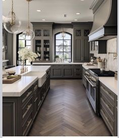 a large kitchen with gray cabinets and white counter tops