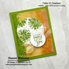 a close up of a card on a white background with green and orange accents,