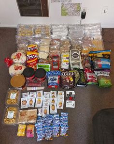 an assortment of food and snacks laid out on the floor