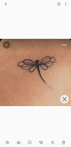 the back of a woman's neck with a dragonfly tattoo on her chest