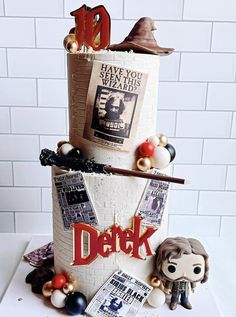 a three tiered cake with harry potter decorations