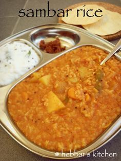 there is a metal tray with food on it and the words sambar rice in front of it