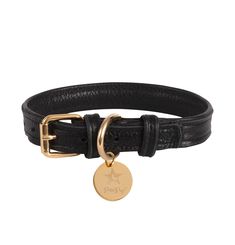 a black leather bracelet with a gold plated charm on the clasp and a star