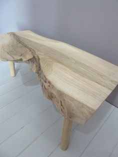 a wooden bench sitting on top of a white floor