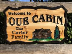 a wooden sign that says welcome to our cabin the carrier family on it's side