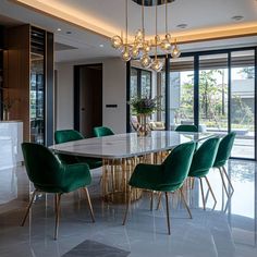 a dining room table surrounded by green chairs