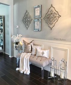 a living room filled with lots of furniture and decor on top of a hard wood floor